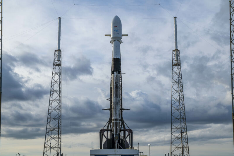 A space missile directed at the sky full of clouds.